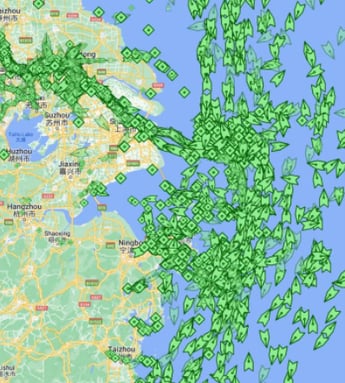 A recent overview of freighters waiting around the Port of Shanghai.